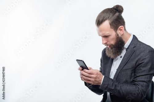 confused man reading info in his phone. bad news or shocking post on social network. © golubovy