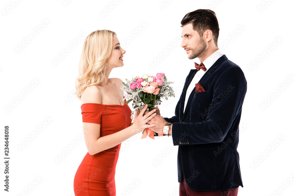 Side view of handsome man giving flowers to girlfriend isolated on white Side view of handsome man giving flowers to girlfriend isolated on white