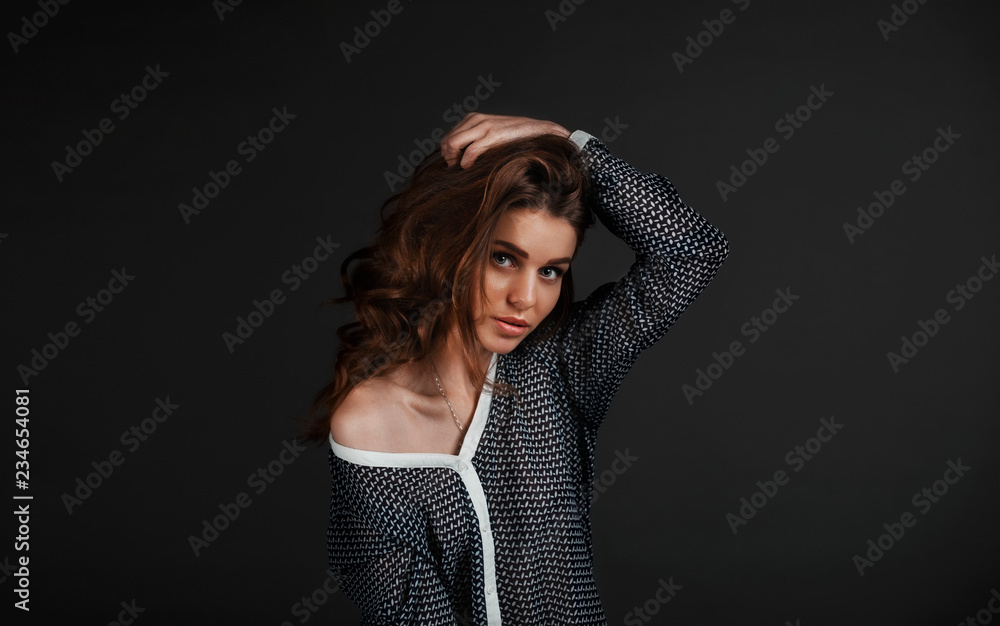 Girl on a black background, large portrait, makes even hair a hand Girl on a black background, large portrait, makes even hair a hand