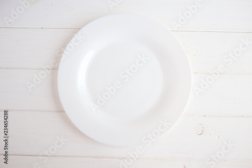 White plate on wooden background