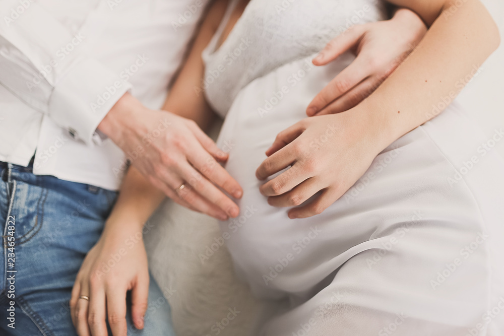 Pregnant wife with husband. Man touching belly of pregnant woman. Family waiting for baby. Pregnant wife with husband. Man touching belly of pregnant woman. Family waiting for baby.