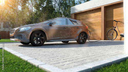 Modernes Elektroauto zu Hause Strom tanken braunes SUV mit E-Bike im Hintergrund