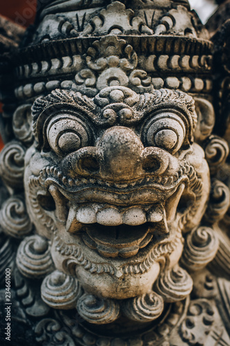 Closeup portrait of Hindu Buddhist traditional stone sculpture. Bali, Indonesia