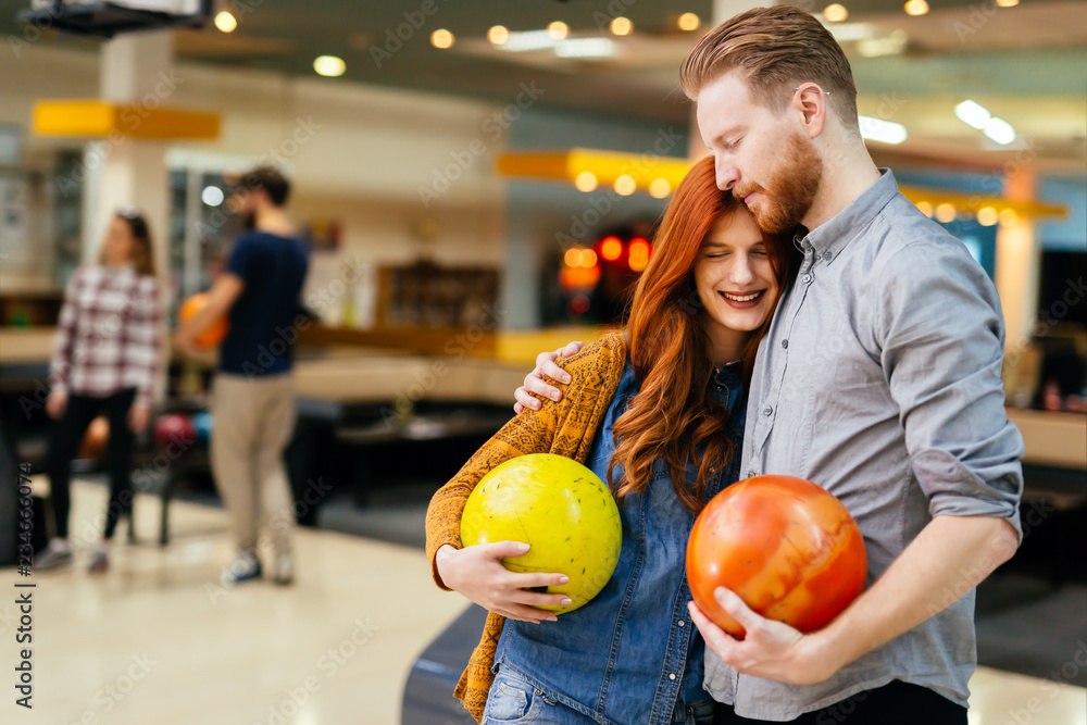 Fototapeta premium Cheerful friends bowling together and having fun
