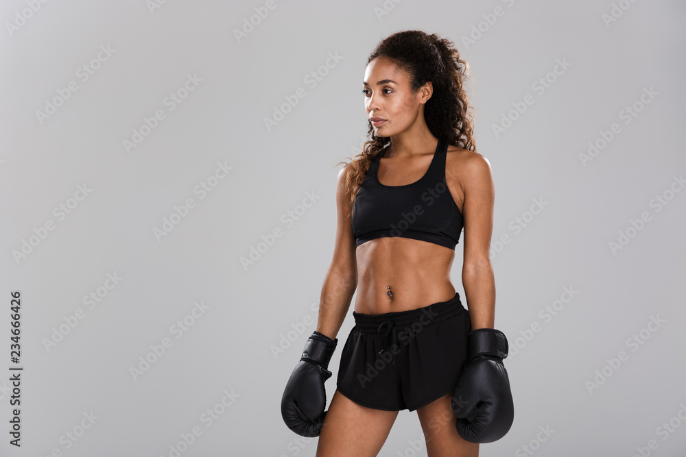 Beautiful african sportswoman isolated over gray Beautiful african sportswoman isolated over gray