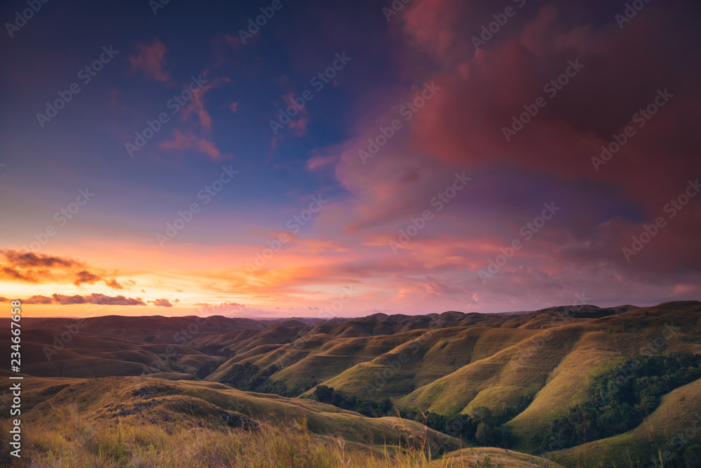 Colorful sunset sky over mountain panorama, Merdeka Hill, Bukit Wairinding, East Sumba, Indonesia. Travel Background. Nature landscape. Untouched wild island