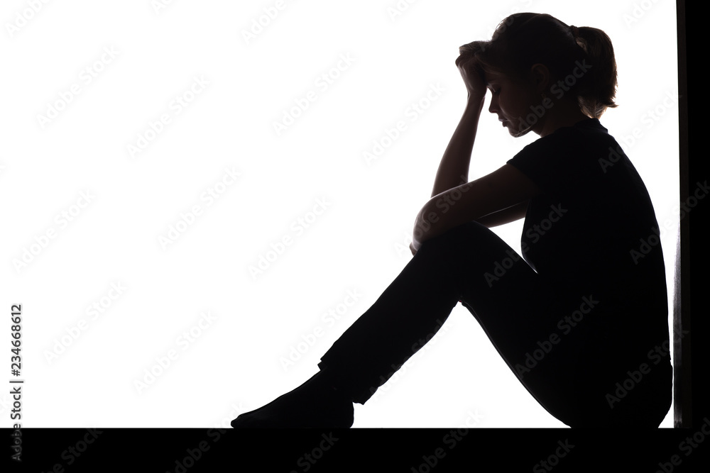 © fantom_rd - silhouette of a woman sitting on the floor in a corner on a white isolated background, a sad girl thinking about problems, concept of depression © fantom_rd - silhouette of a woman sitting on the floor in a corner on a white isolated background, a sad girl thinking about problems, concept of depression