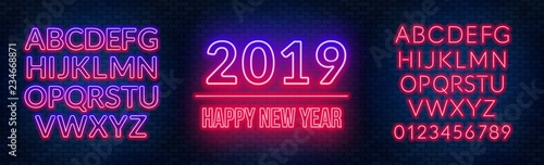 Neon sign happy new year on a dark background with bright alphabets.