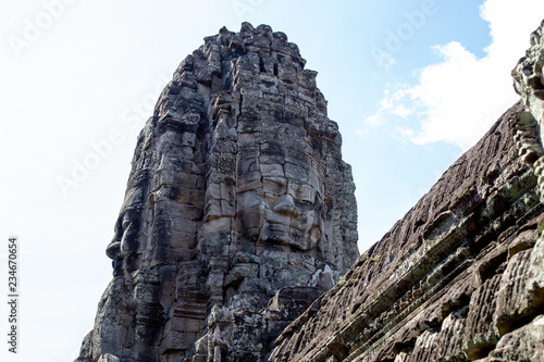 Ancient temple name Bayon Angkor with stone faces Siem Reap, Cambodia. Bayon's most distinctive feature is the multitude of serene and smiling stone faces on the many towers  © chayakorn