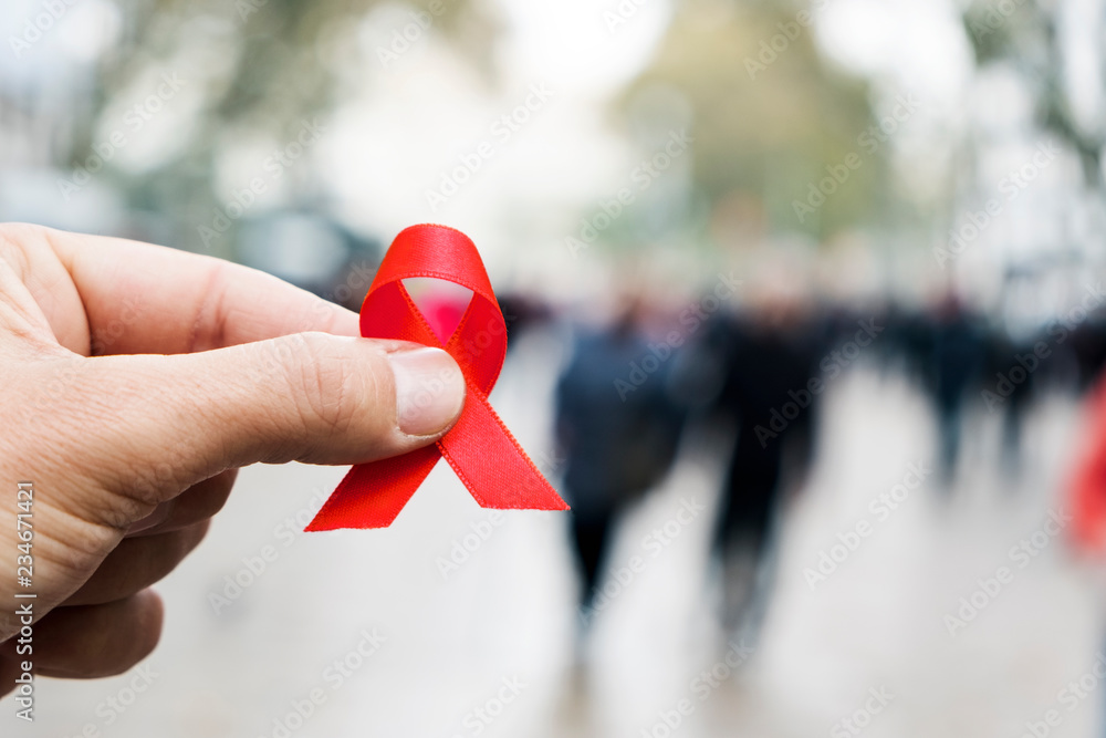 Fototapeta premium man with a red ribbon for the fight against AIDS