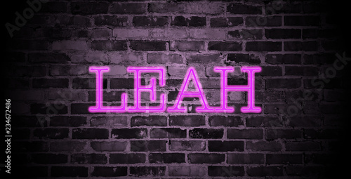 first name Leah in pink neon on brick wall