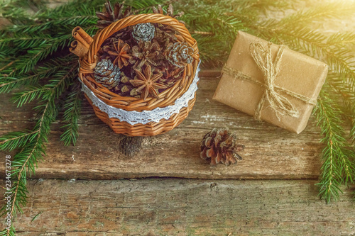 Christmas New Year composition with gift box fir branch basket pine cones on old shabby rustic wooden background. Xmas holiday december decoration to Russian tradition. Flat lay, copy space