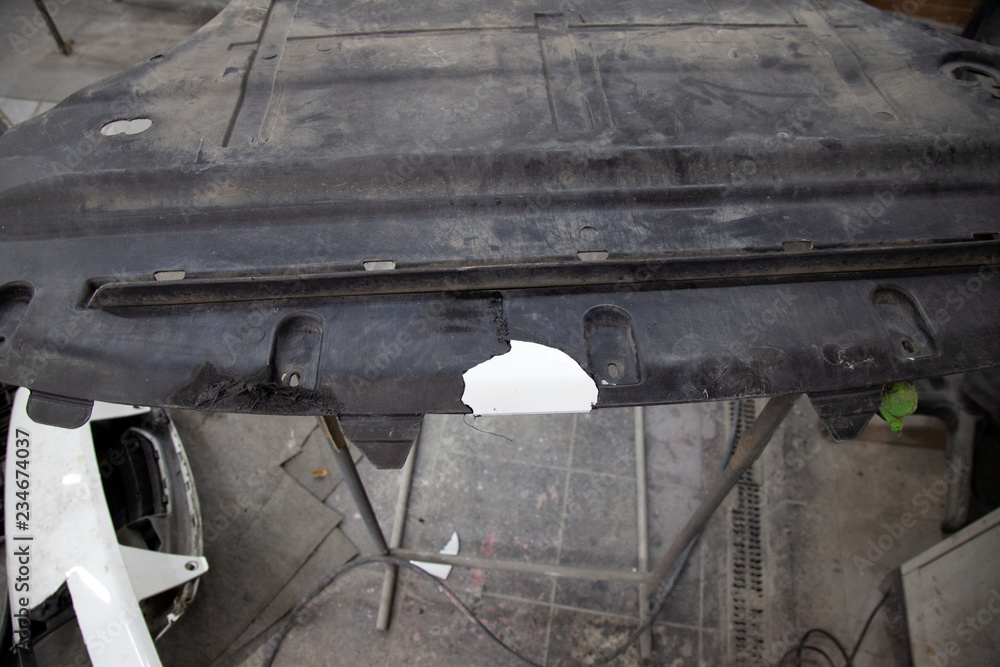 Repair of plastic car body trim by gluing and soldering a broken piece during an accident in a bodywork vehicle workshop Repair of plastic car body trim by gluing and soldering a broken piece during an accident in a bodywork vehicle workshop