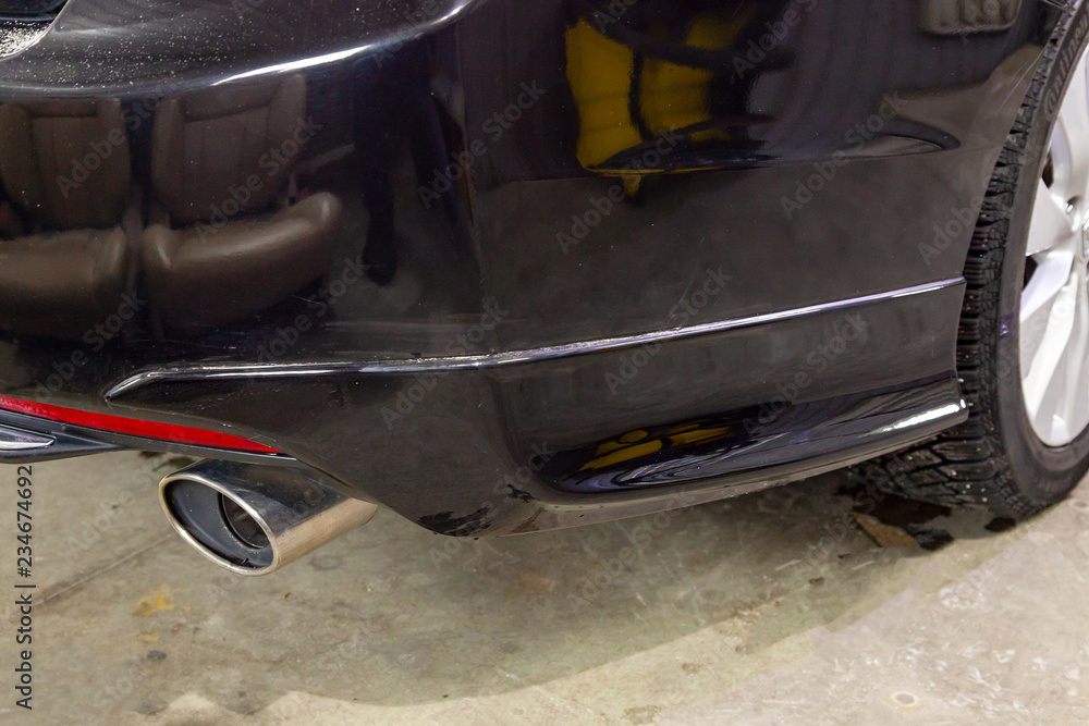 Sedan-class car body elements of rear bamper from close range before and after polishing and nanoceramic coating in a vehicle detailing workshop Sedan-class car body elements of rear bamper from close range before and after polishing and nanoceramic coating in a vehicle detailing workshop