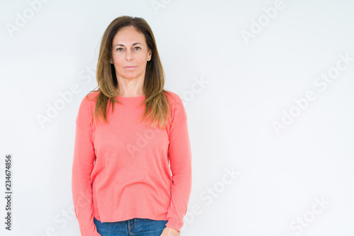 Beautiful middle age woman over isolated background Relaxed with serious expression on face. Simple and natural looking at the camera. © Krakenimages.com