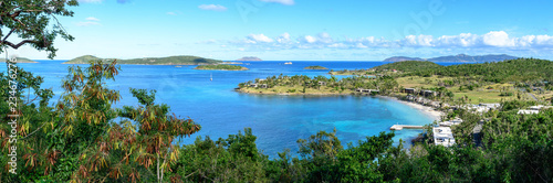 Panoramic landscape of tropical marine blue lagoon with wild green jungle in the foreground. High resolution