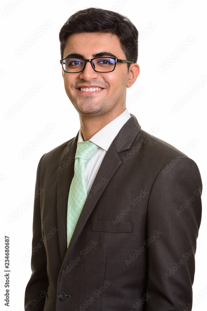 Young happy Persian businessman smiling and looking at camera Young happy Persian businessman smiling and looking at camera