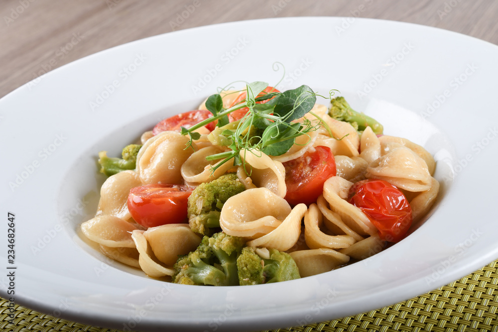 Orecchiette with cherry tomatoes, broccoli and anchovies, Italian food 
