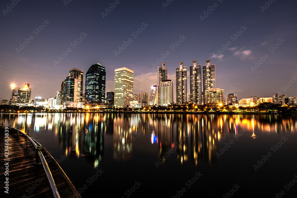 Fototapeta premium Modern night city skyline with lights reflection
