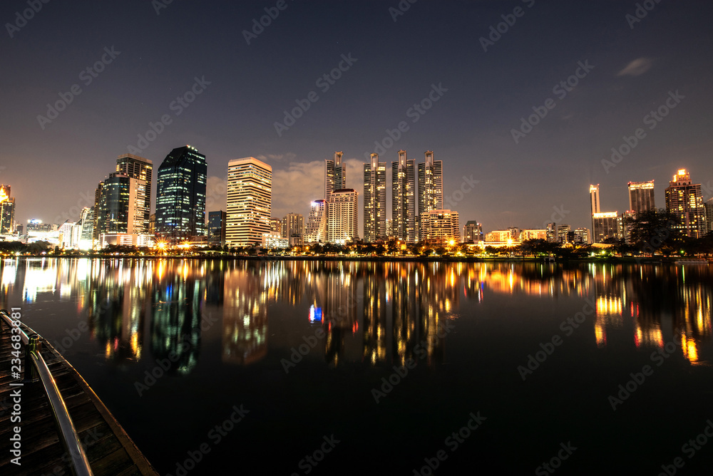 Modern night city skyline with lights reflection