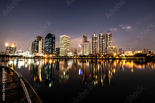 Modern night city skyline with lights reflection