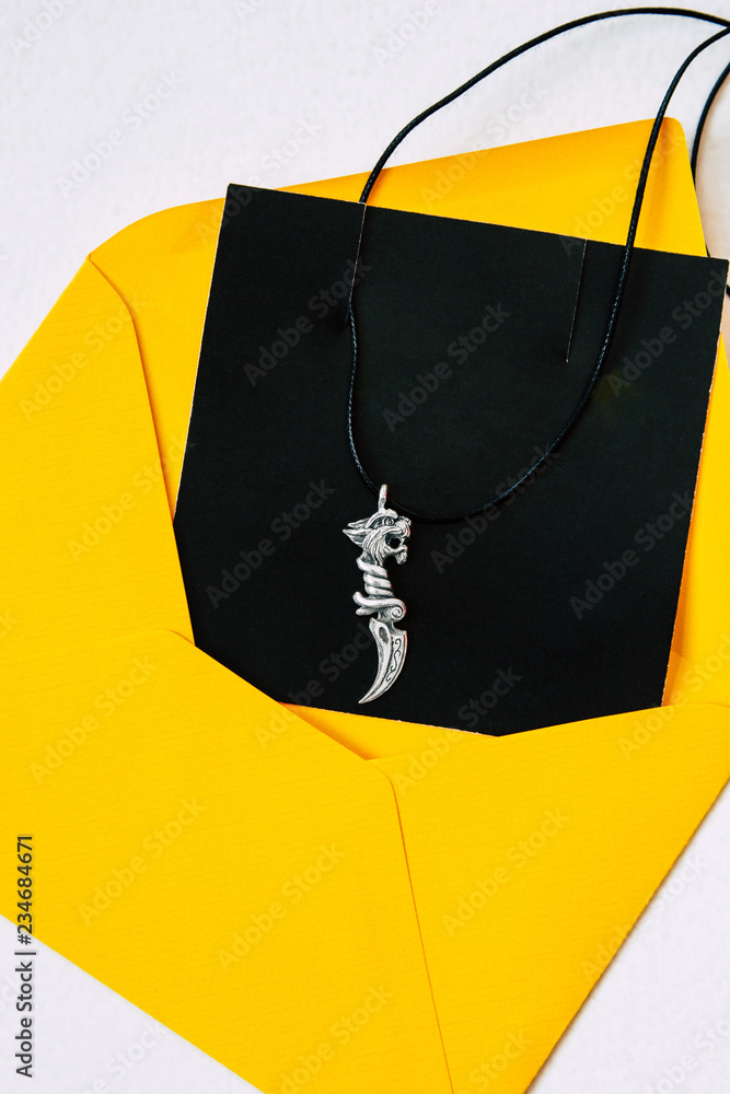 Silver pendant with yellow envelope Silver pendant with yellow envelope