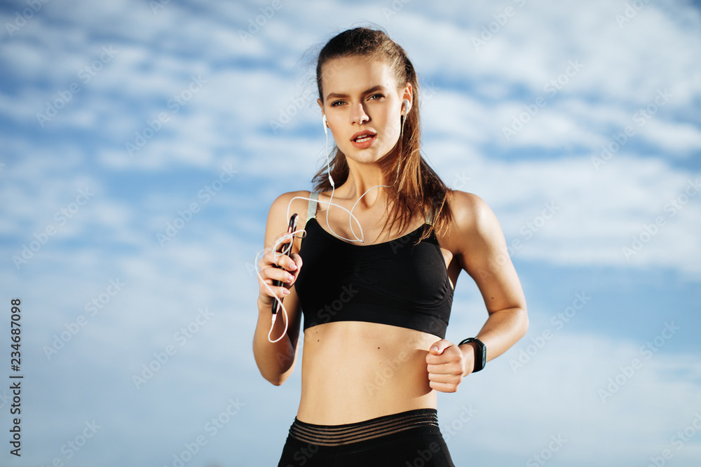 Early morning workout. Happy Beautiful women running in the headphones. Living healthy lifestyle. Early morning workout. Happy Beautiful women running in the headphones. Living healthy lifestyle.
