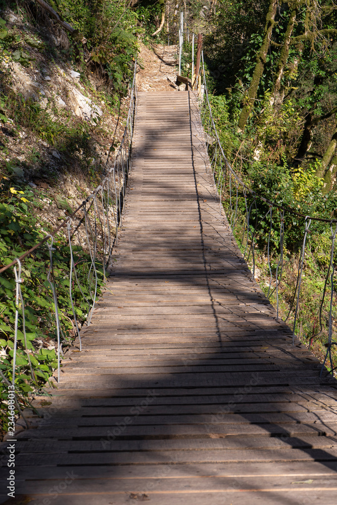 Wooden suspension bridge in the mountains. Trekking