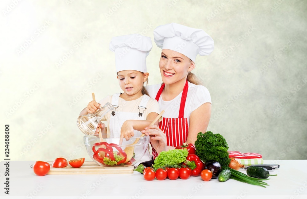 Cute little girl with vegetables in kitchen Cute little girl with vegetables in kitchen