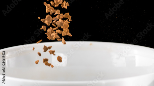 Preparation of instant coffee in a white mug on a white and black background © Vasily Popov