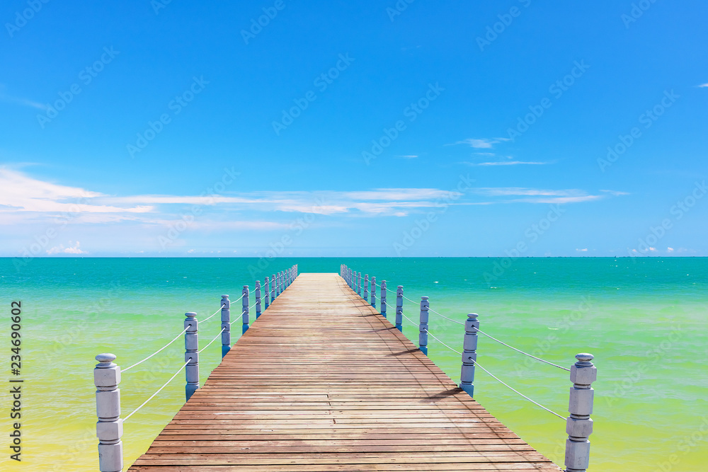 wooden bridge juts out into  of the sea
