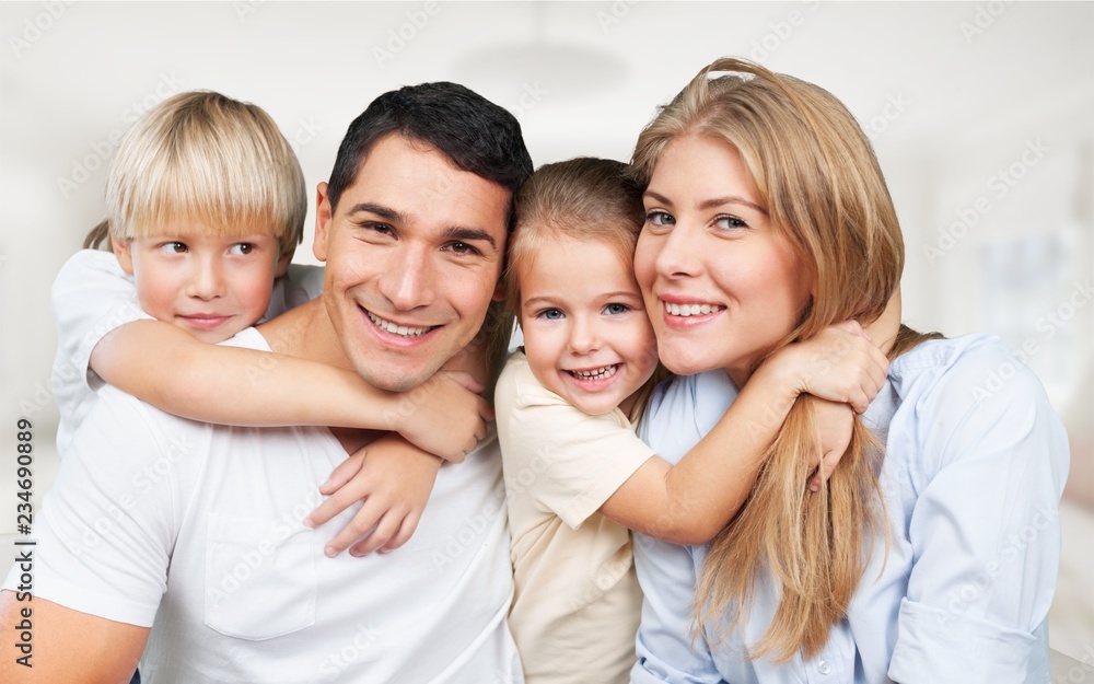 Beautiful smiling family sitting at sofa at home Beautiful smiling family sitting at sofa at home