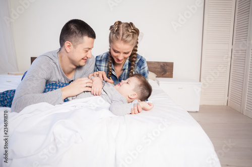 mom dad and young son in the bedroom after sleeping House