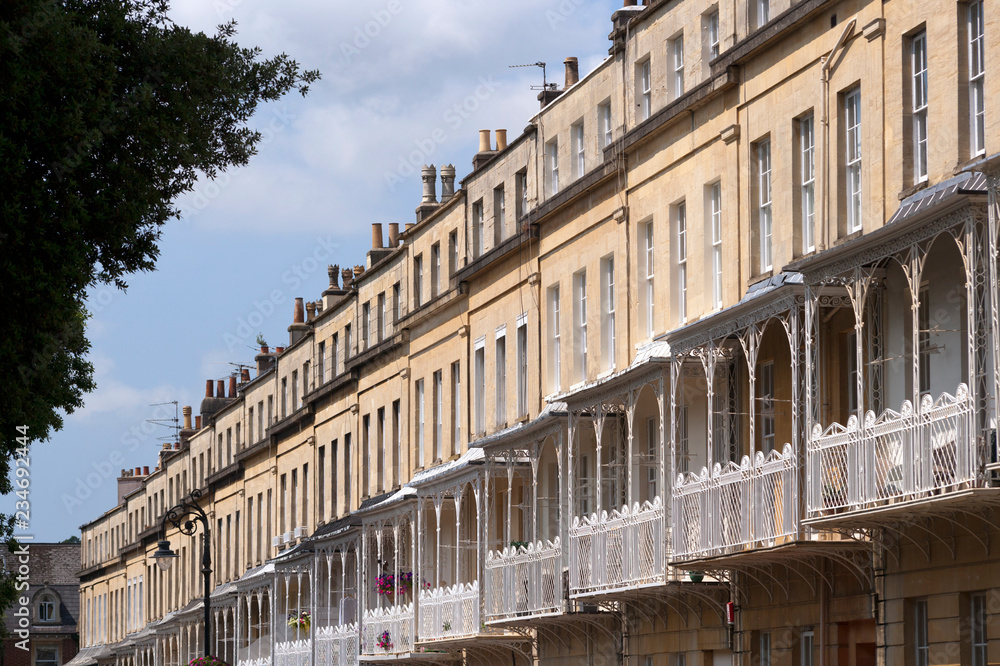 A row of ornate canopied balconies on terraced town houses in the Clifton area of Bristol, UK