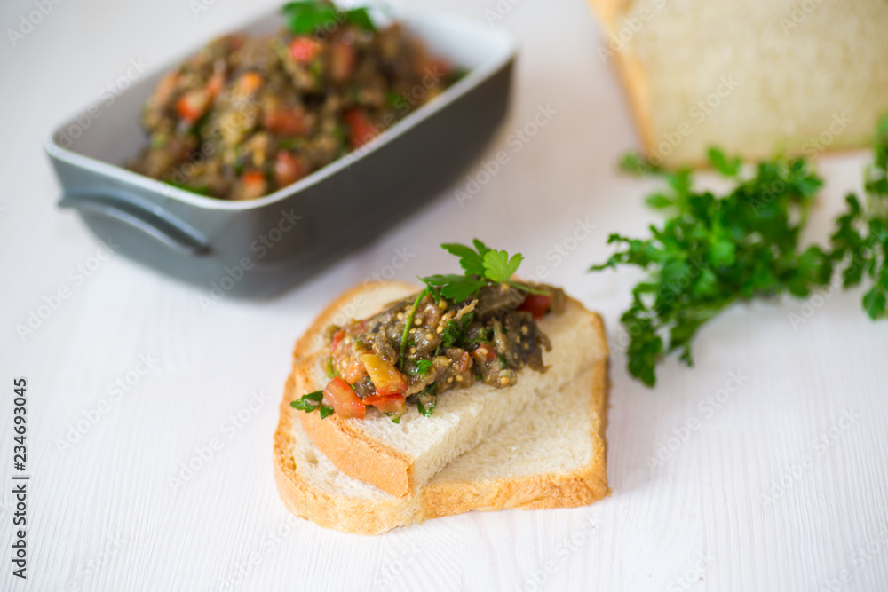 eggplant caviar with tomatoes and a slice of bread eggplant caviar with tomatoes and a slice of bread