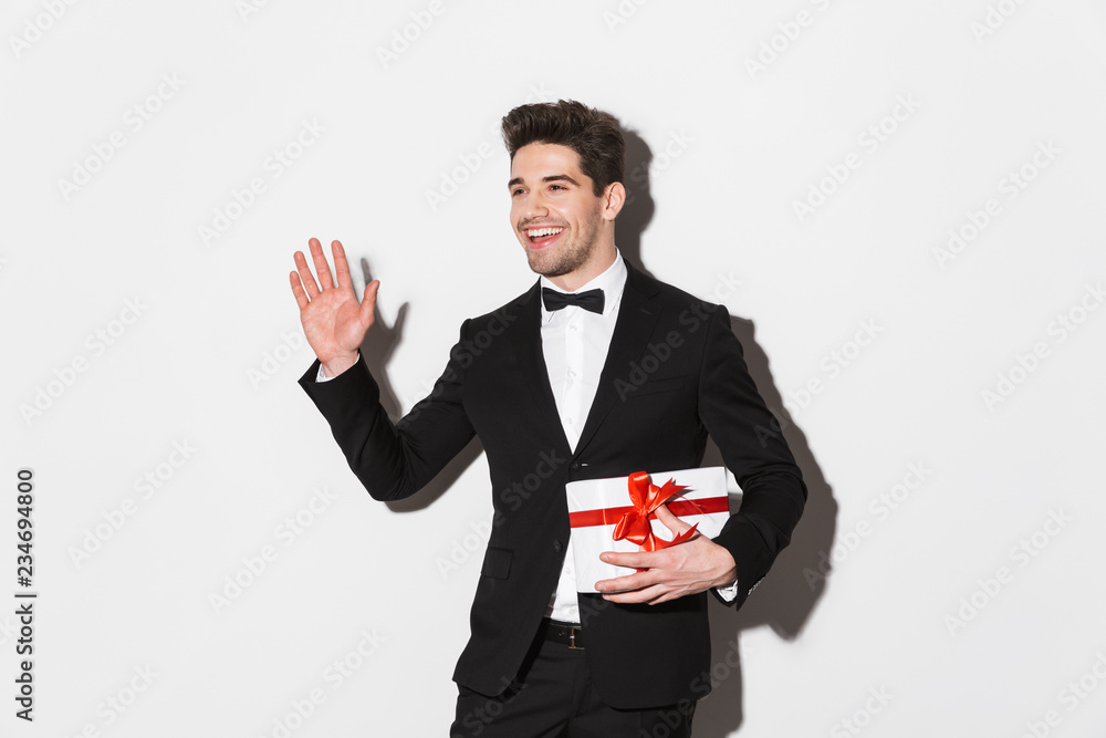 Portrait of a cheerful young man wearing black suit Portrait of a cheerful young man wearing black suit