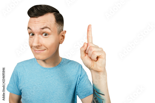 Portrait of young thinking guy with finger up isolated on a white background.