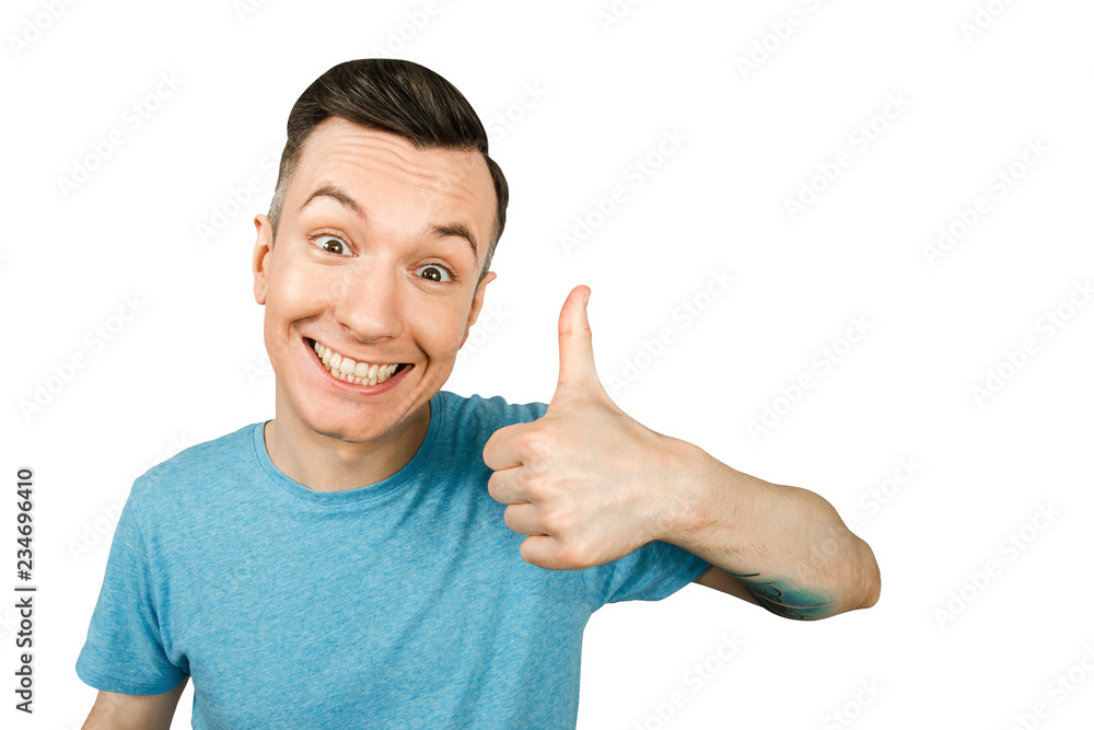 Portrait of young smiling guy showing thumb up isolated on a white background. Portrait of young smiling guy showing thumb up isolated on a white background.