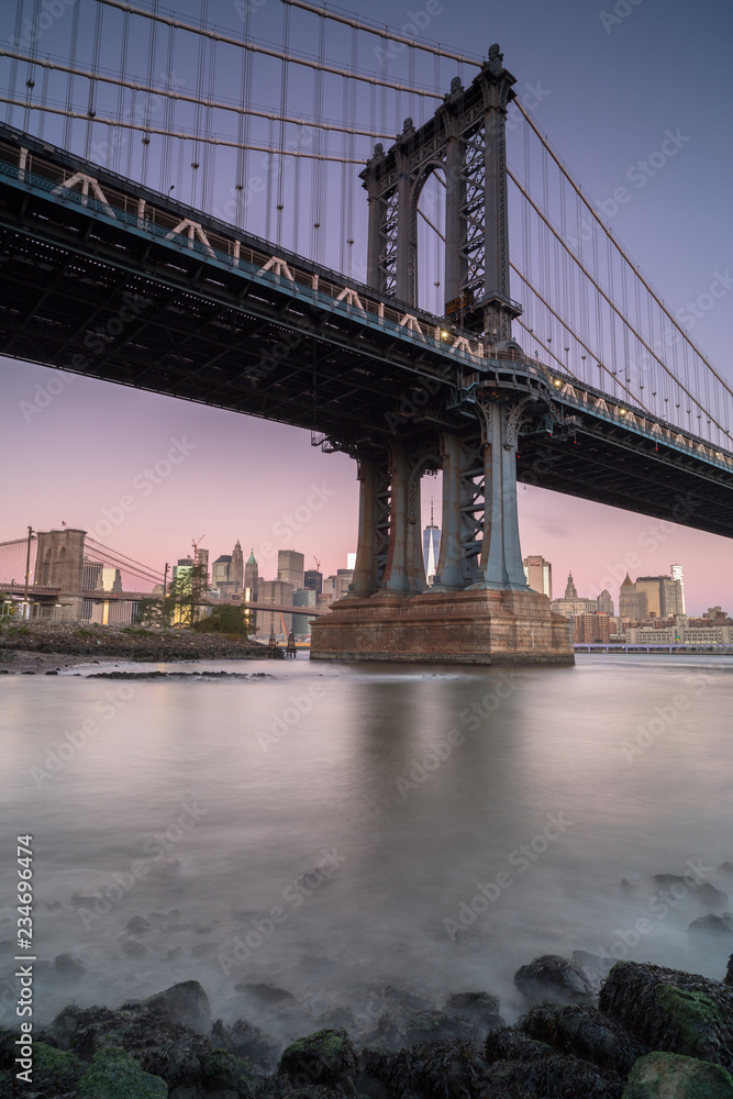 View on Manhattan bridge from east river at sunrise