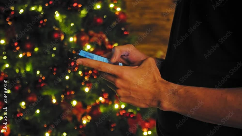 hand using mobile smart phone with colorful light celebration background 4K hand using mobile smart phone with colorful light celebration background 4K