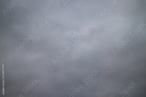 gray autumn sky drops on a window pane