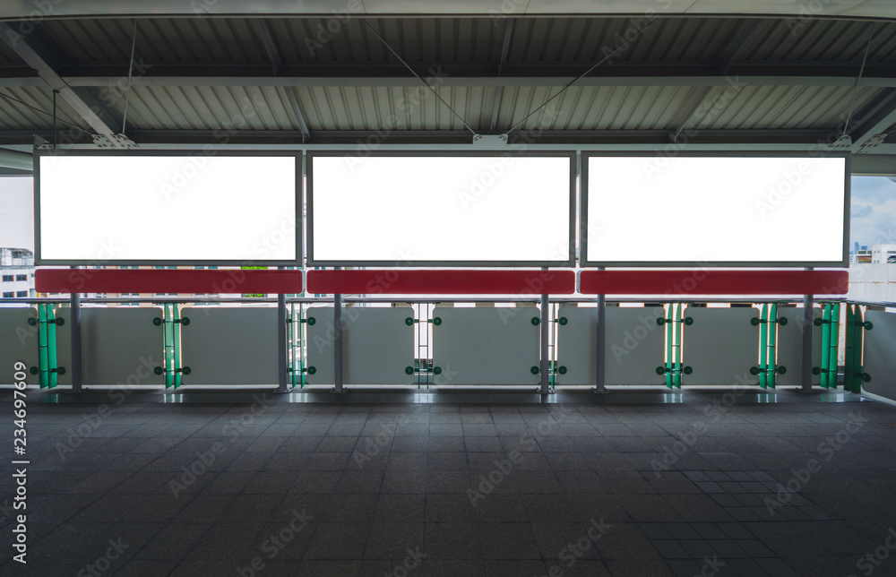 Obraz premium billboard big blank white three LED screen horizontal outstanding at side way people walking on sky train for display advertisement text template promotion new brand indoor.