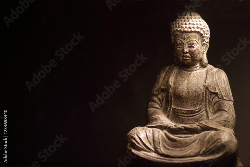 Statue of Buddha on dark background