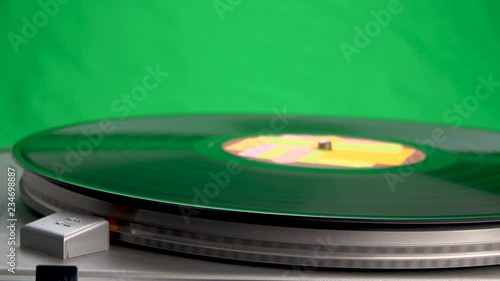 Rotating vinyl player with a plate on a background of green chroma key color.