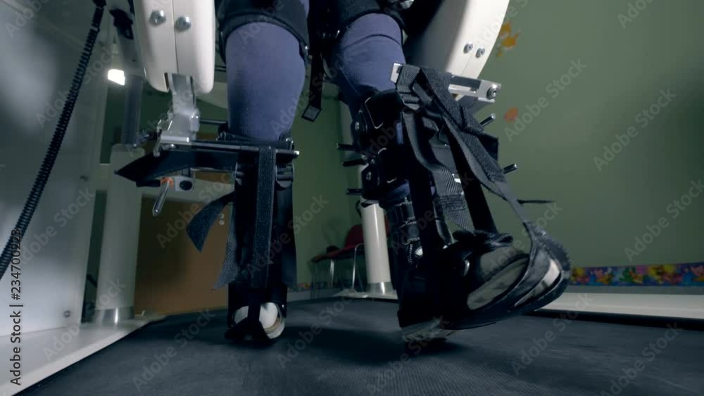 Close up of fixated legs walking along the simulation machine Close up of fixated legs walking along the simulation machine