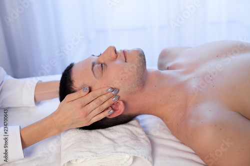 a massage therapist makes man medical back massage and body treatments at the Spa