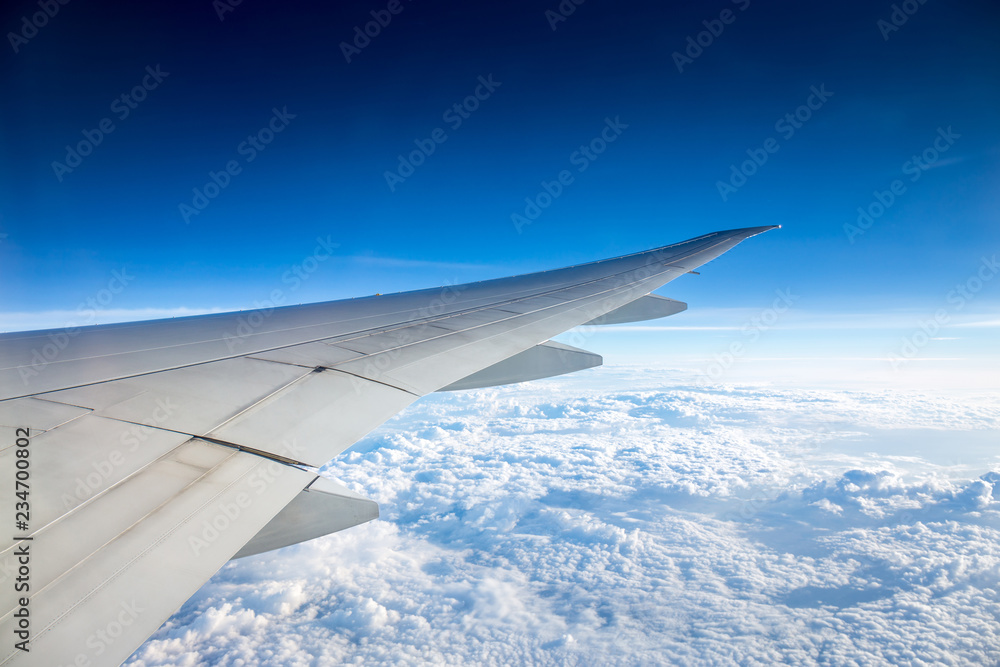 Aerial, or top view of amazing clear blue sky and cloud after sunrise and takeoff from airport from window view of airplane with airplane view during air transportation