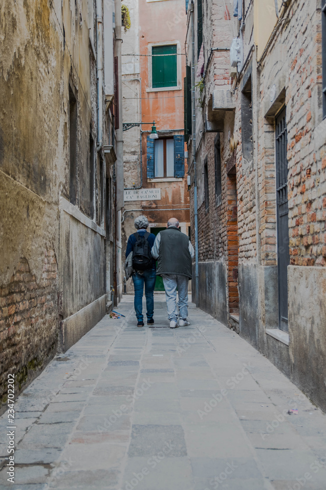 Alley in old town. Older couple (Venice - Italy)