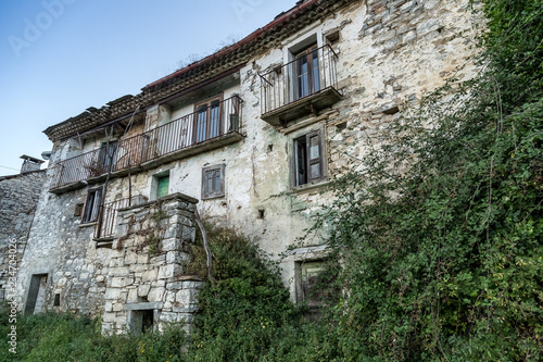 An old abandoned house in Agnone with green garden leaves  Italy.