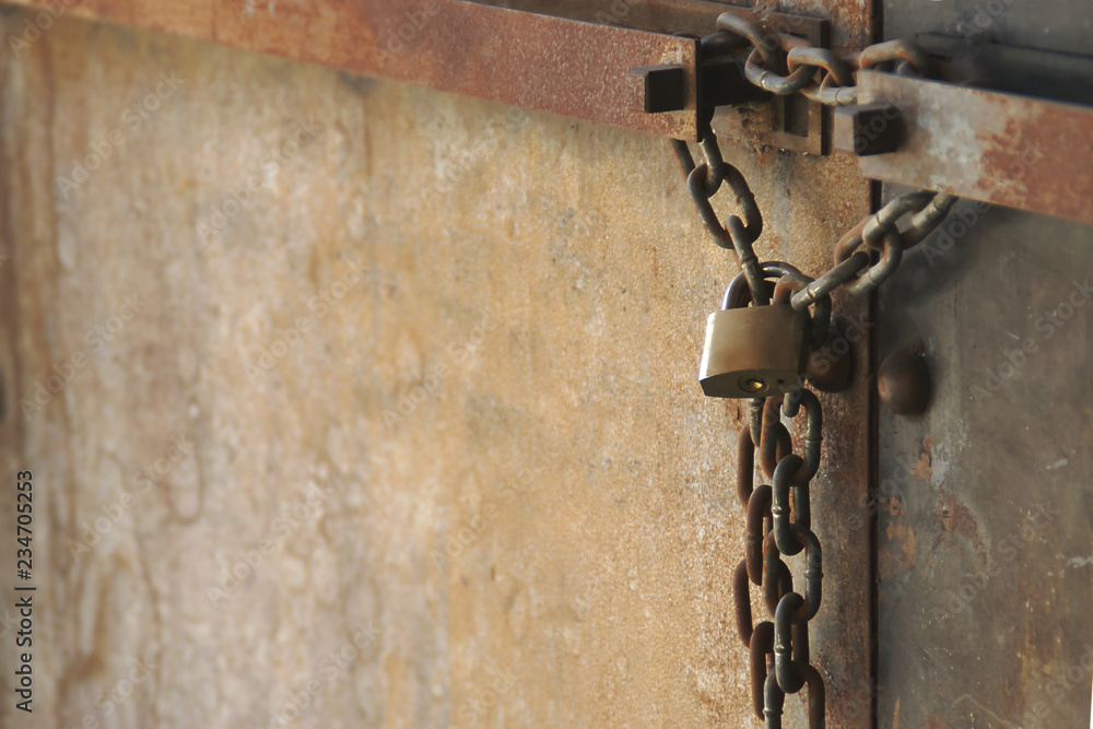 Rusty Chain with Lock on old Metal Double Doors Rusty Chain with Lock on old Metal Double Doors